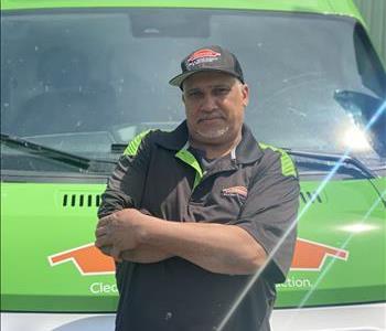 Man standing in front of green SERVPRO® truck to pose for photo