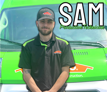 Man leaning against green SERVPRO® van to pose for photo