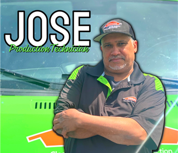 Man standing in front of green SERVPRO® truck to pose for photo